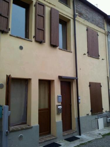 a building with many doors and windows on it at San polo house in Parma