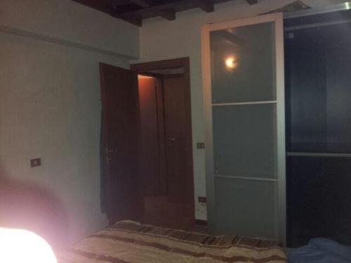 a bedroom with a bed and a book shelf at San polo house in Parma