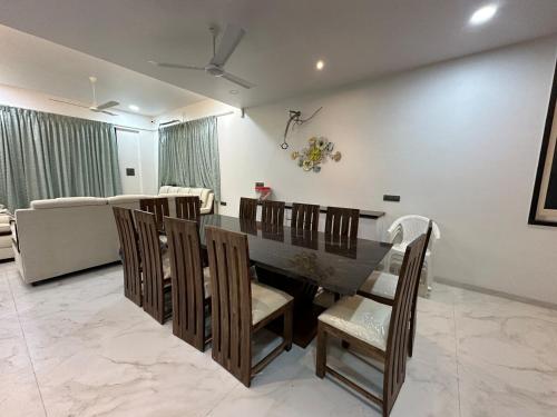 a dining room with a table and chairs at Triveni Stays 5 BHK Pure Veg Villa in Lonavala in Kārli