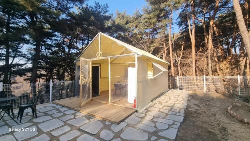 a small yellow and white shed with a porch at Bauhaus In Wonju in Wonju