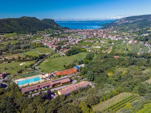 an aerial view of a town with a train at Poiano Garda Resort Hotel in Garda