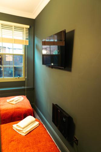 a bedroom with two beds and a window at Town Centre Apartments with Spa in Morpeth