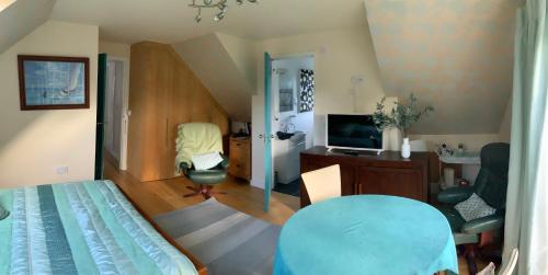a bedroom with a bed and a desk and a television at Hurstbourne in Camberley