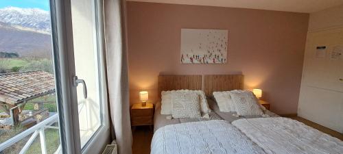 a small bedroom with two beds and a window at Chambre d'hôte de Reymure in Vif