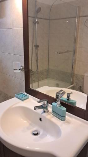 a bathroom sink with a mirror and a shower at Agia Effimia RIVIERA APPARTMENT in Agia Effimia