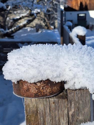 a pile of snow on top of a wooden post at Appartement Seppi in Innsbruck