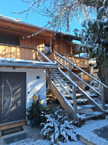 a house with a staircase in the snow at Appartement Seppi in Innsbruck