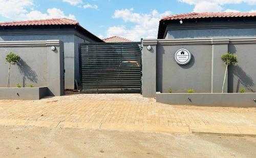 a building with a gate and a garage at Felo Guest House in Balmoral