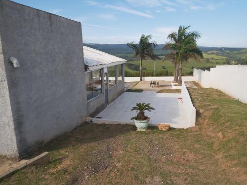 a house with a porch with a potted plant next to it at Chácara para final de semana em família in Sorocaba