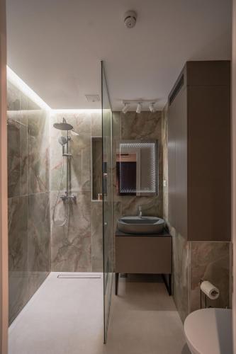 a bathroom with a sink and a shower at Lotus 1 in Ploieşti