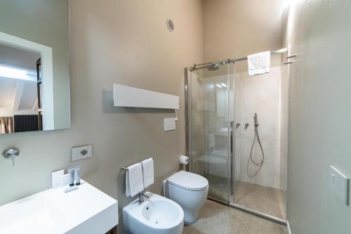 a bathroom with a shower and a toilet and a sink at Modena Relax Luxury Rent Rooms in Modena