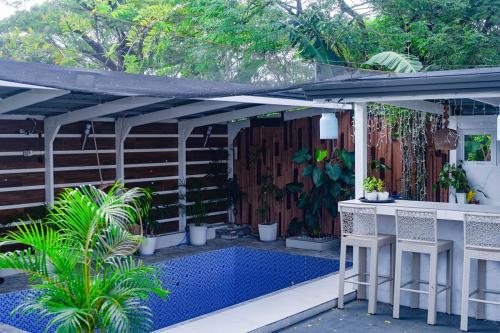 a patio with a pool and a pergola at White House Cabin Cozy Retreat with Rustic Charm in Hermosa