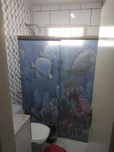 a bathroom with an ocean themed shower stall with fish at Beautiful house in the campoline the best neighborhood of sorocaba in Sorocaba