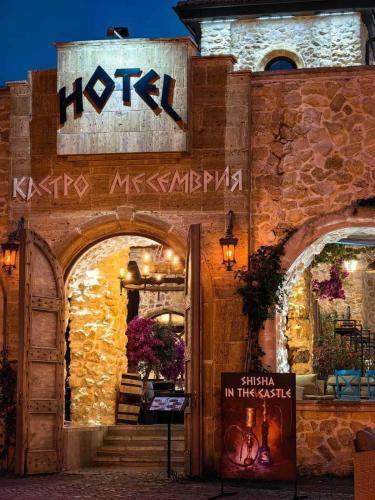 a hotel with a sign on the side of a building at Castro Mesembria Boutique Hotel in Nesebar