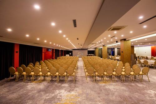 an empty hall with chairs and a podium in a room at Karpalas City Hotel & Spa in Bolu