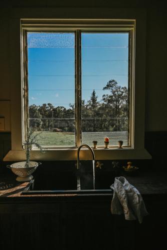 a kitchen with a sink and a window at Two Brothers' Cabin in Deeside