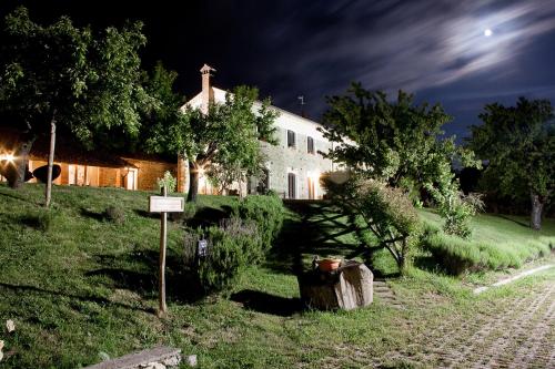 a house on a hill with a sign in front of it at La Rosa Nel Bicchiere in Soveria Mannelli