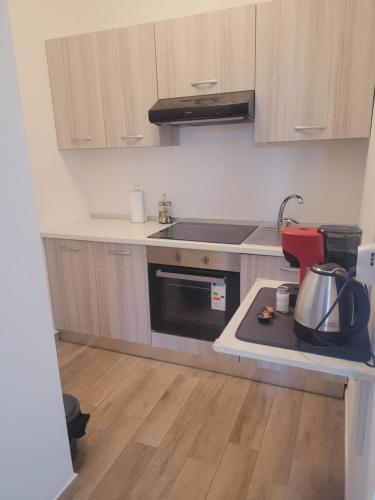 a kitchen with a sink and a stove top oven at HOUSE AIRPORT Catania 3 in CTA