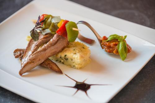 a plate of food with meat and vegetables on it at Casa Di fiore in Maubourguet