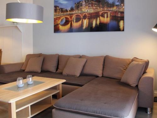 a living room with a couch and a table at Ferienhaus Nr 12, Kategorie Komfort, Feriendorf Hochbergle, Allgäu in Lechbruck