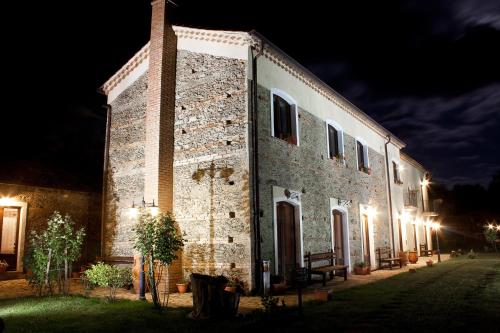 a large brick building with lights on it at night at La Rosa Nel Bicchiere in Soveria Mannelli