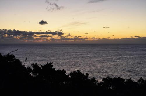 a sunset over a body of water at AJITO in Oshima