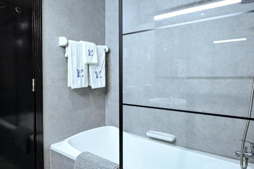 a bathroom with a glass shower door and a sink at Modern Studio in Discovery Gardens, Close to Metro in Dubai