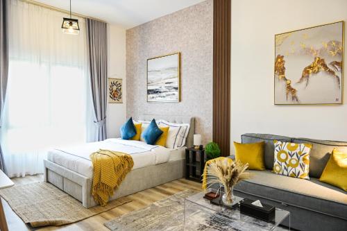 a hotel room with a bed and a couch at Modern Studio in Discovery Gardens, Close to Metro in Dubai