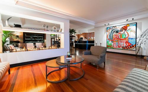 a living room with a couch and a table at Hotel Hita "Nature Experience" for all in Navacerrada
