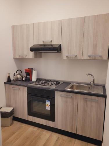 a kitchen with a stove and a sink at HOUSE AIRPORT Catania 4 in CTA