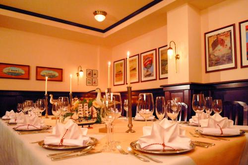 a long table with wine glasses and napkins on it at Dünenhotel am Meer in Warnemünde