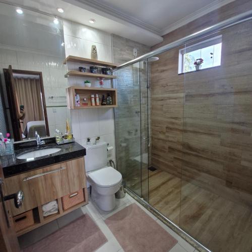 a bathroom with a shower and a toilet and a sink at COP 30 Casa luxo mobiliada em condomínio in Ananindeua