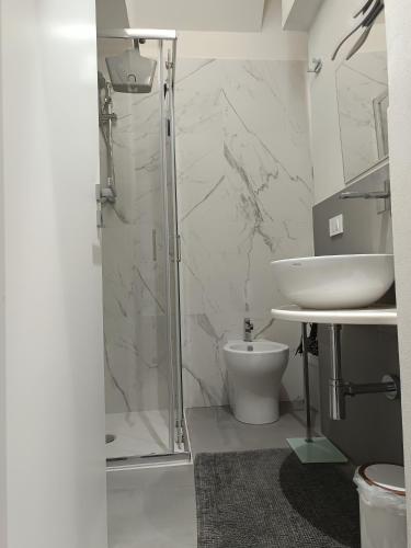 a bathroom with a shower and a toilet and a sink at Le Suite Angelo&Alice Mini in Marsala