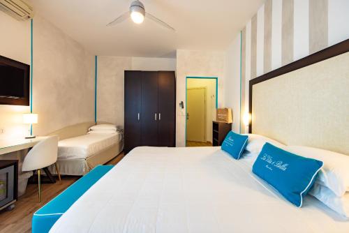 A bed or beds in a room at UNAHOTELS Imperial Sport Hotel