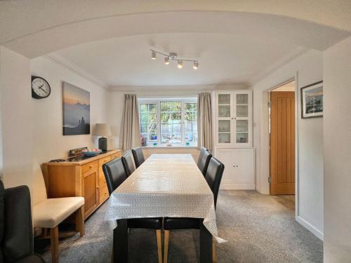a dining room with a table and chairs and a desk at 4 Bed Retreat with Balcony & Estuary views in Exeter