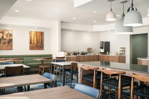 a restaurant with tables and chairs and a counter at Fairfield Inn Tallahassee North/I-10 in Tallahassee
