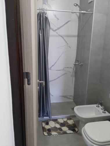 a bathroom with a shower and a toilet at Centro Carlos Paz Cibeles in Villa Carlos Paz