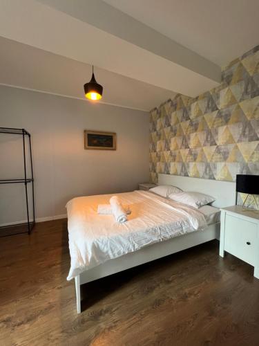 a bedroom with a bed and a lamp and a table at Apartament B&B Cajvana in Cajvana