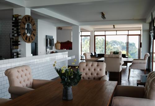 a dining room with a table and chairs at Umurobyi Lodge in Kibuye