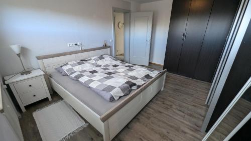 ein Schlafzimmer mit einem Bett mit einer karierten Decke in der Unterkunft Garten 2-Zimmer WHG in Bestlage in Rottach-Egern, 400m vom See in Rottach-Egern