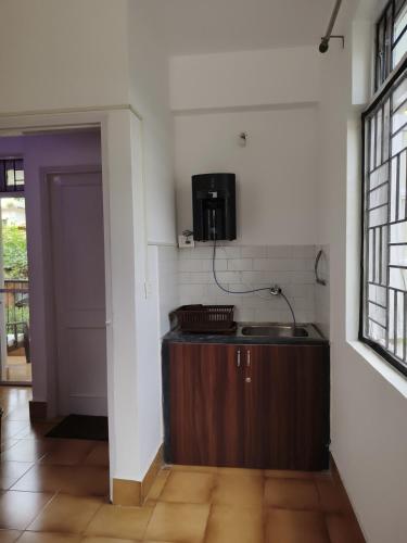 a kitchen with a sink and a microwave at Beachside Studio 302 - Calangute Goa in Calangute