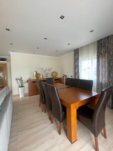 a dining room with a wooden table and chairs at Casa Luar- suite rooms in Praia do Carvoeiro