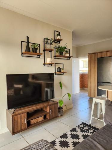 a living room with a large flat screen tv at Entire Modern Apartment, Couples Sunset Getaway in Ballito