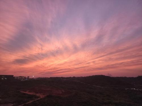 a sunset over a hill with a sky at Entire Modern Apartment, Couples Sunset Getaway in Ballito