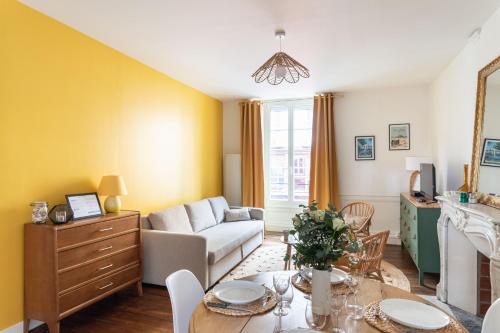 un salon avec une table et un canapé dans l'établissement Le Soleil Malouin - Proche Parc de Bel-Air, à Saint-Malo
