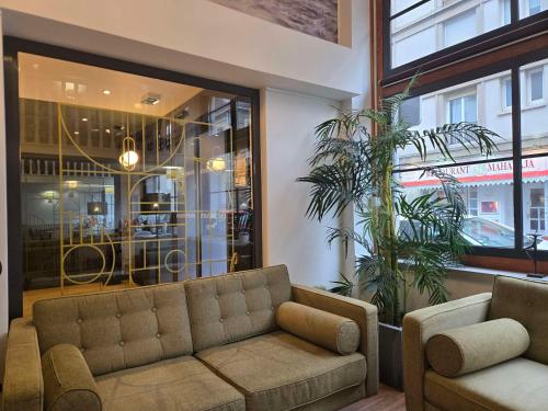 a living room with a couch in front of a store at Sure Hotel By Best Western Lorient Centre in Lorient