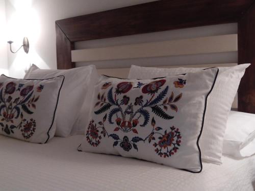a bed with two pillows and two pillows on it at Casa Fidela in Lomeña