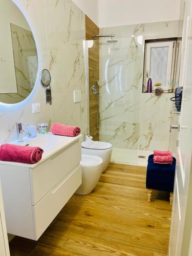 a bathroom with a sink and a toilet and a shower at Domus Lucia in Syracuse