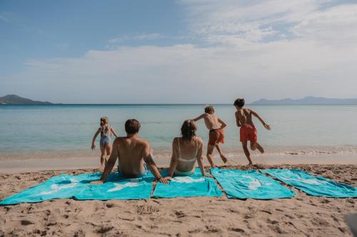 a group of people playing on the beach at Iberostar Waves Playa de Muro in Playa de Muro