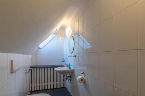 a bathroom with a sink and a toilet and a light at Vakantiehuis Siedling in Winterberg